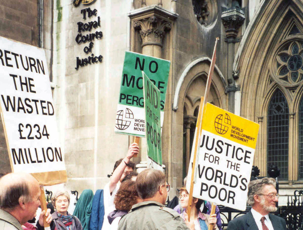 Protesters with placards outside the UK High Court, 1994