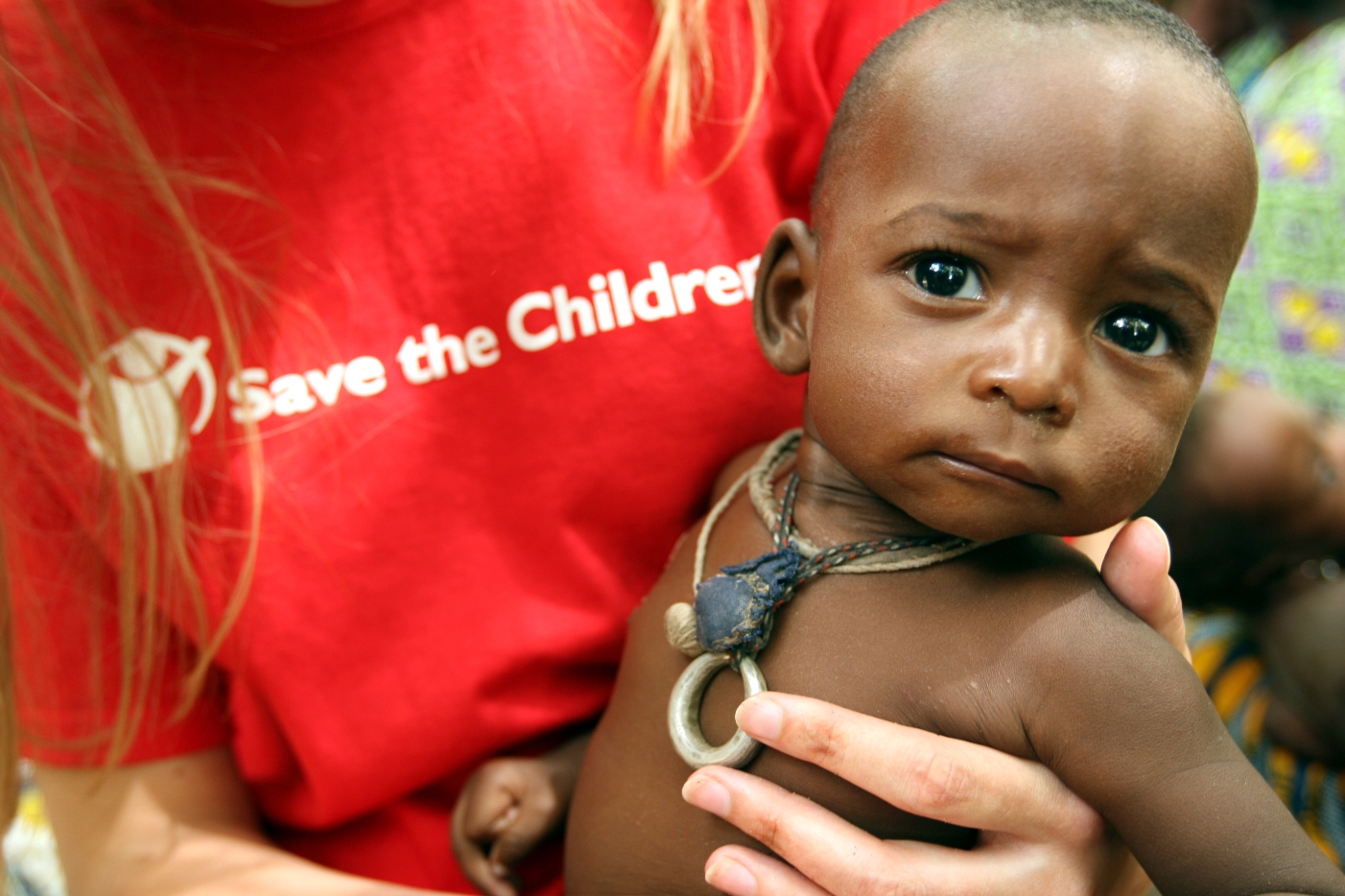 Save the Children UK staff member, Susannah Parker, holds seven month-old Abdou Bassinou at Bande feeding centre