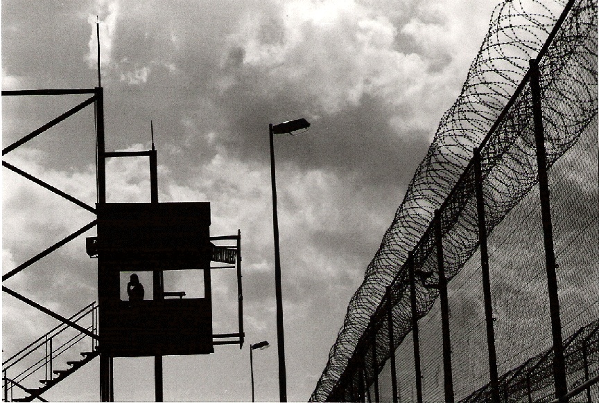 A guard tower by a fence