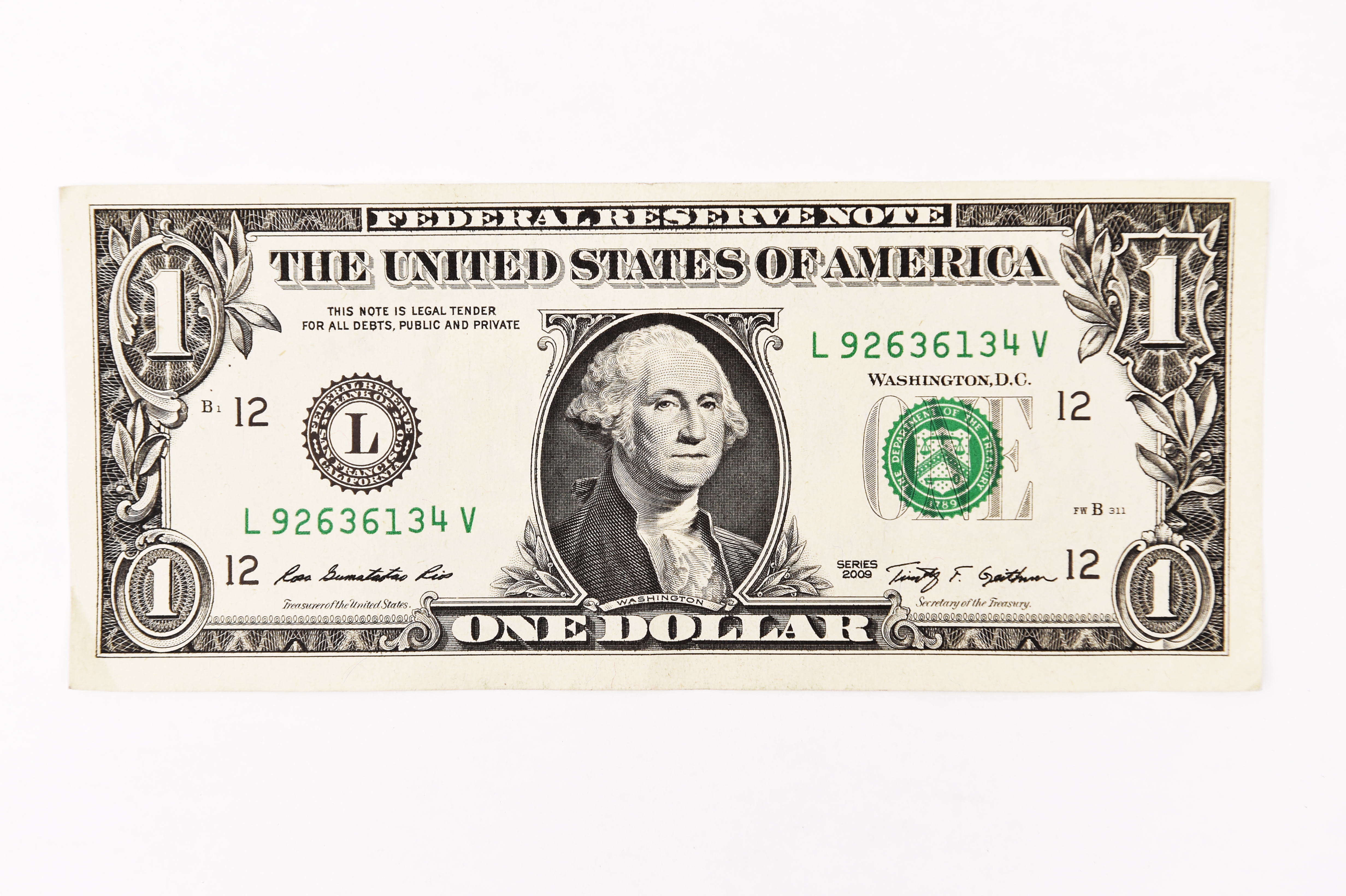 Close up of one dollar isolated on white background.