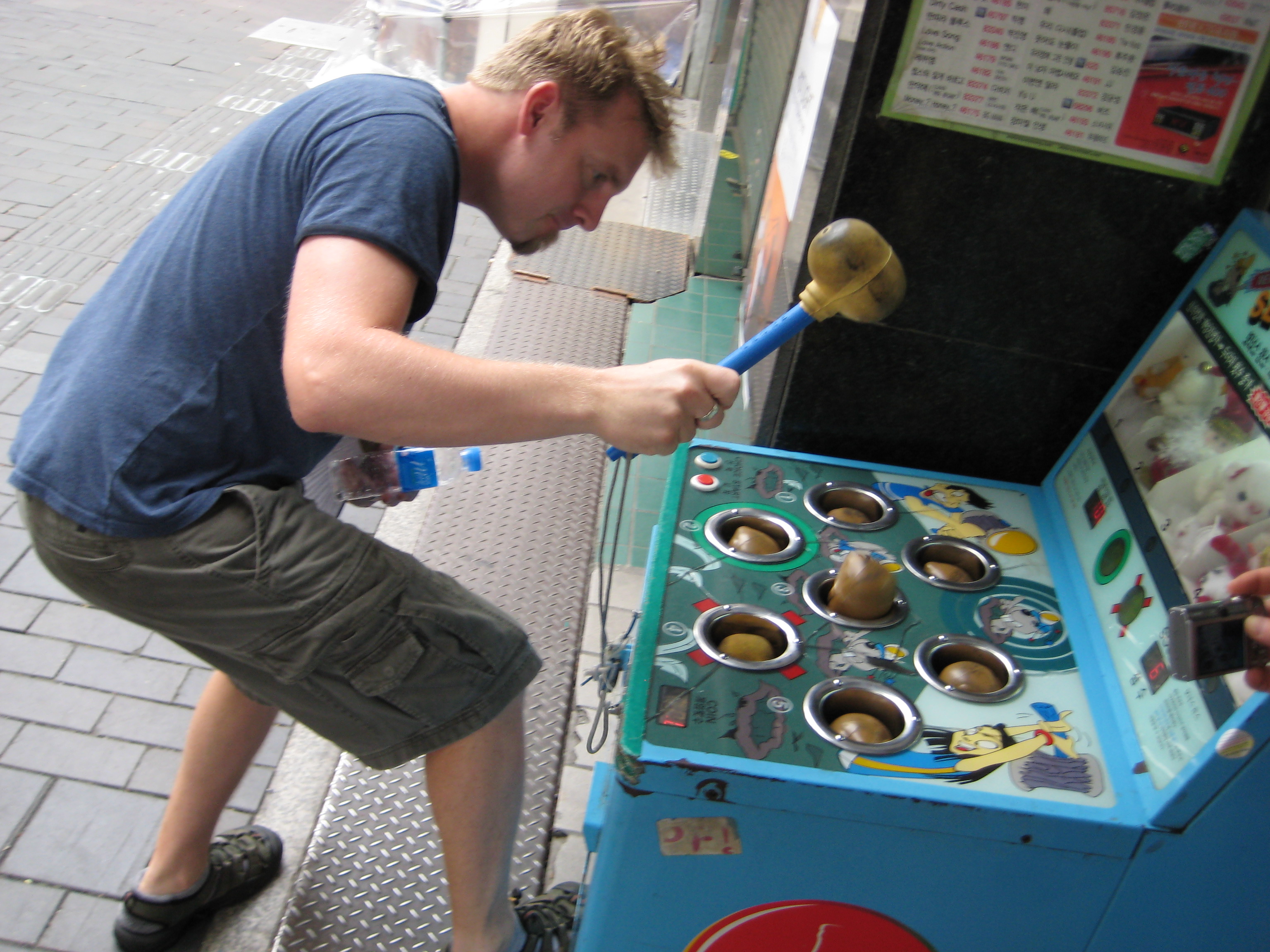 om playing Korean Whack a Mole in Insadong Seoul Korea.